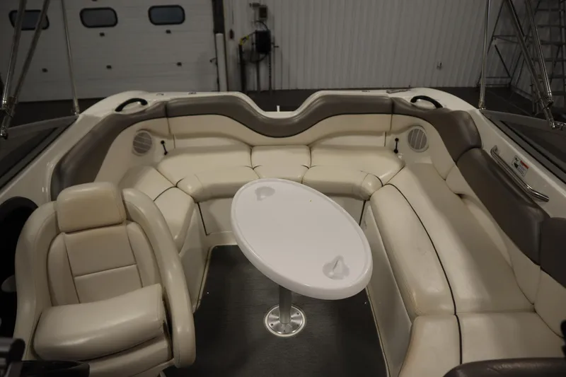 Slide: The Image of 2010 Yamaha 210 SX boat interior with white seating and oval table. - 37