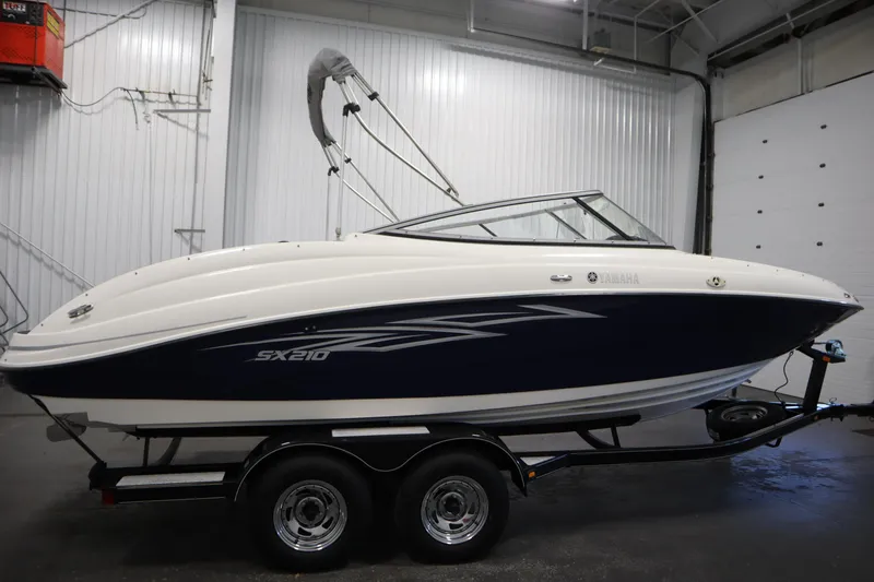 Slide: The Image of 2010 Yamaha 210 SX boat on trailer in indoor storage facility. - 4