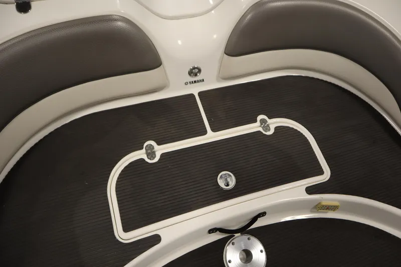 Slide: The Image of Interior view of a 2010 Yamaha 210 SX boat with cushioned seating. - 42