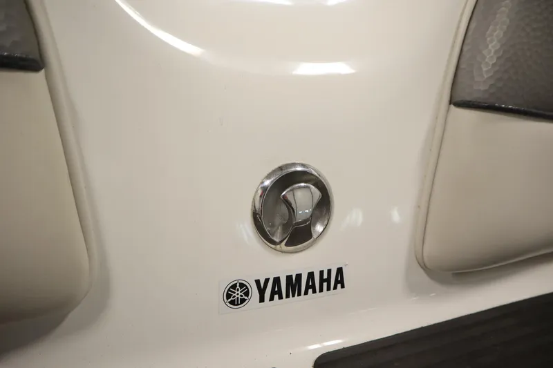 Slide: The Image of Close-up of 2010 Yamaha 210 SX boat emblem and logo on white surface. - 44