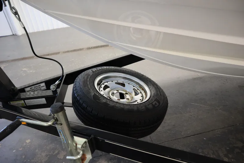 Slide: The Image of 2010 Yamaha 210 SX boat on trailer with spare tire visible. - 48