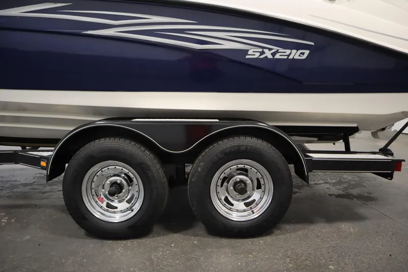 Slide: The Image of 2010 Yamaha SX210 boat on trailer with dual wheels, side view. - 50