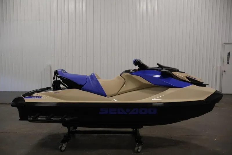 Slide: The Image of 2026 Sea-Doo Wake 170 jet ski in beige and blue, displayed indoors. - 10