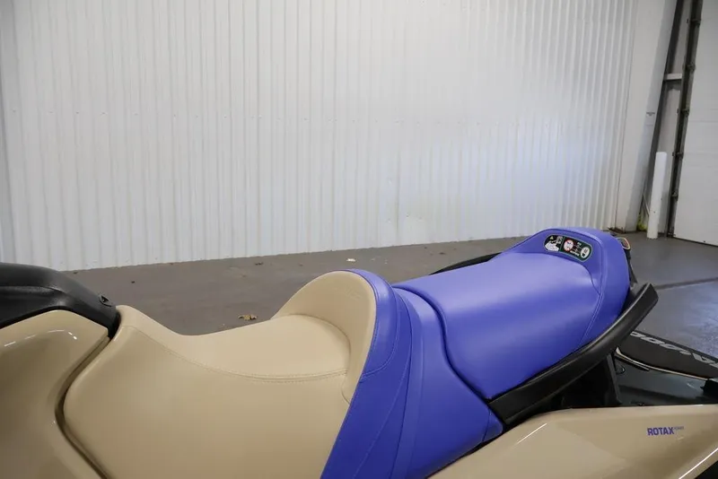 Slide: The Image of 2026 Sea-Doo Wake 170 jet ski with beige and blue seating in a garage setting. - 18