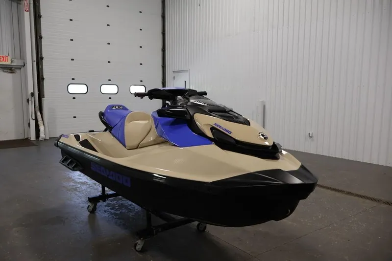 Slide: The Image of 2026 Sea-Doo Wake 170 jet ski in a garage, featuring a sleek beige and blue design. - 2