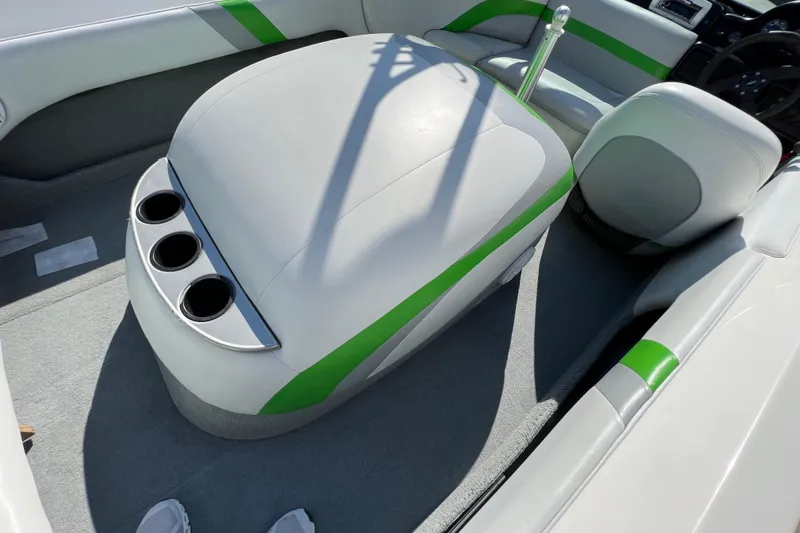 Slide: The Image of 2003 MasterCraft XStar interior with green accents and cup holders. - 17