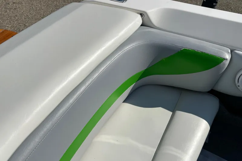 Slide: The Image of 2003 MasterCraft XStar boat interior with white and green upholstery detail. - 18