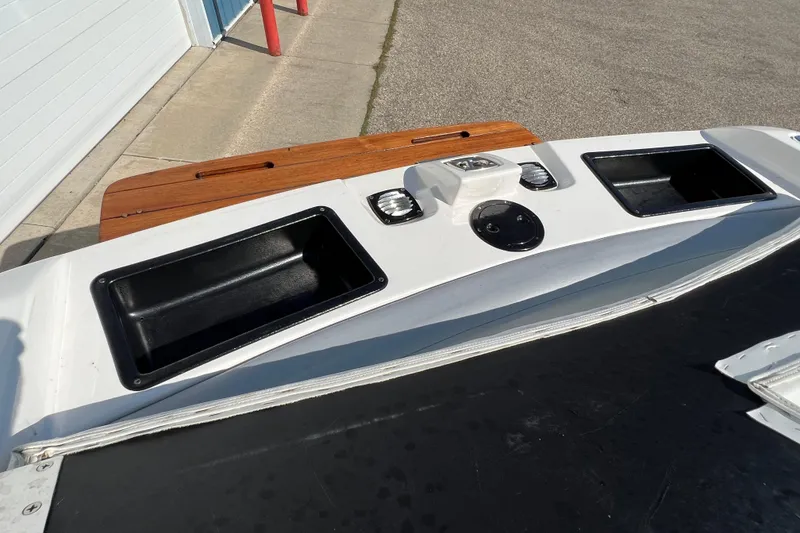 Slide: The Image of 2003 MasterCraft XStar boat stern with storage compartments and teak swim platform. - 20