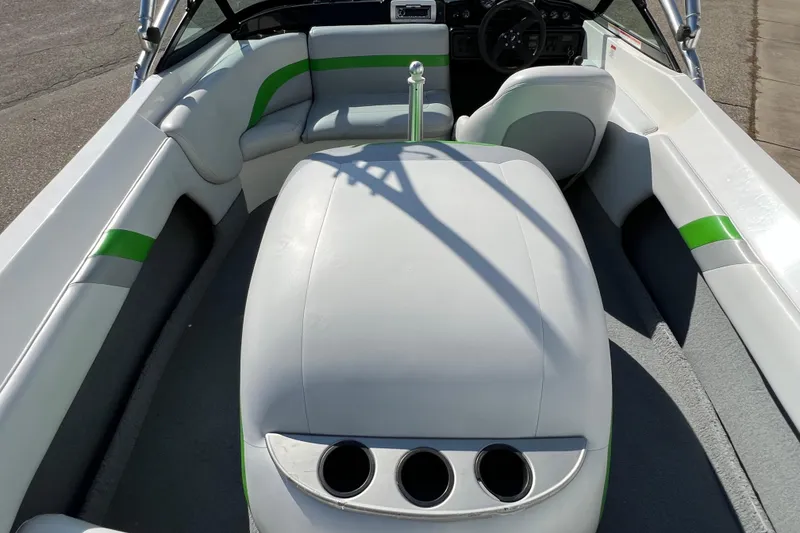 Slide: The Image of 2003 MasterCraft XStar boat interior with white and green seating, steering wheel visible. - 23
