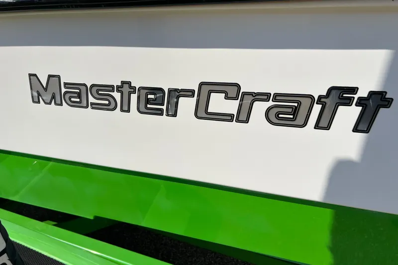 Slide: The Image of 2003 MasterCraft XStar boat logo on white and green hull. - 25