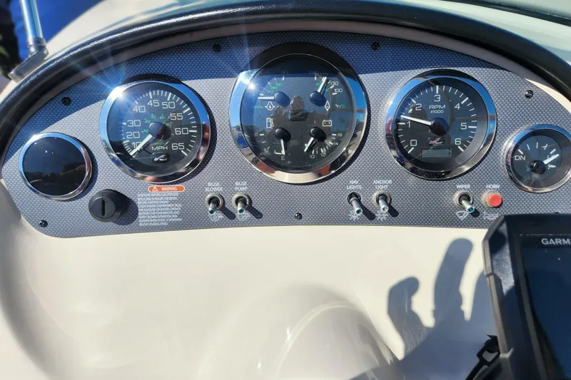 Slide: The Image of Dashboard of a 2008 Sea Ray 205 Sport boat with gauges and controls. - 14