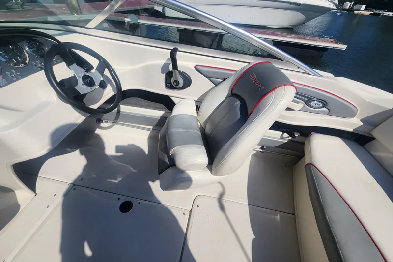 Slide: The Image of 2008 Sea Ray 205 Sport boat interior with steering wheel and seating. - 15