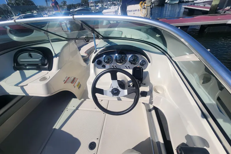 Slide: The Image of 2008 Sea Ray 205 Sport boat interior with steering wheel and dashboard at marina. - 17
