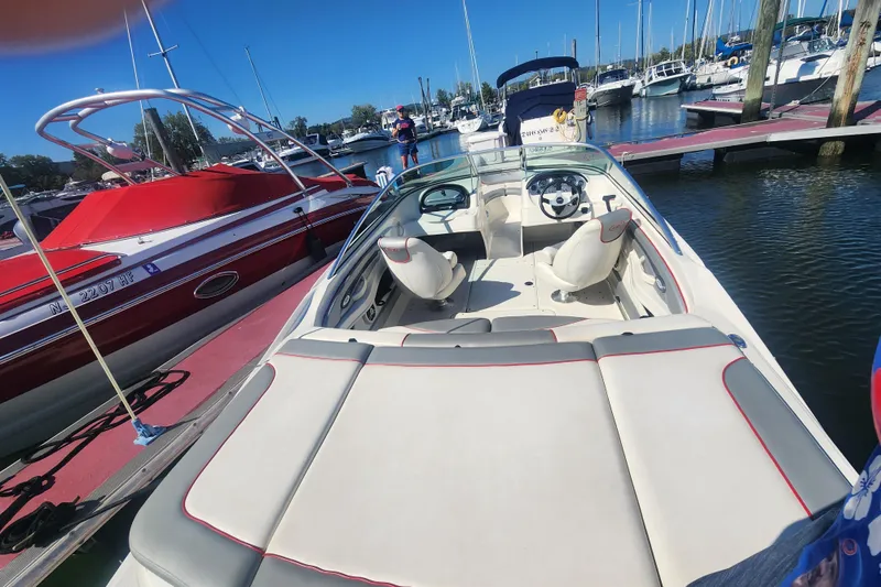 Slide: The Image of 2008 Sea Ray 205 Sport boat docked at marina, interior view with seating. - 18