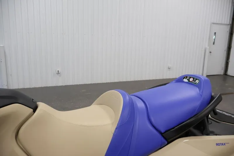 Slide: The Image of 2026 Sea-Doo Wake 170 jet ski with beige and blue seating in a garage setting. - 9