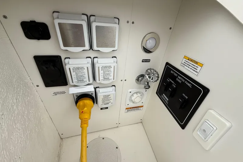 Slide: The Image of 2023 Sea Ray Sundancer 320 Coupe with luxurious white seating and teak flooring. - 22