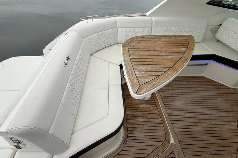 Slide: The Image of 2023 Sea Ray Sundancer 320 Coupe with radar equipment against a cloudy sky. - 26