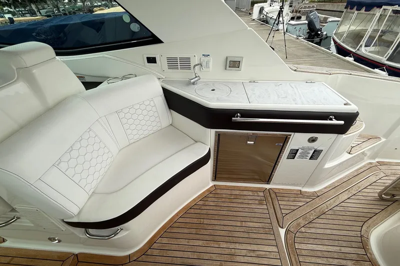Slide: The Image of Luxurious seating area on 2023 Sea Ray Sundancer 320 Coupe yacht with elegant wood table. - 28