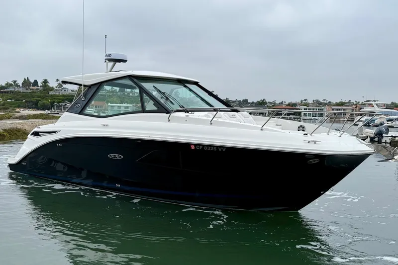 Slide: The Image of 2023 Sea Ray Sundancer 320 Coupe yacht on calm water, side view. - 3