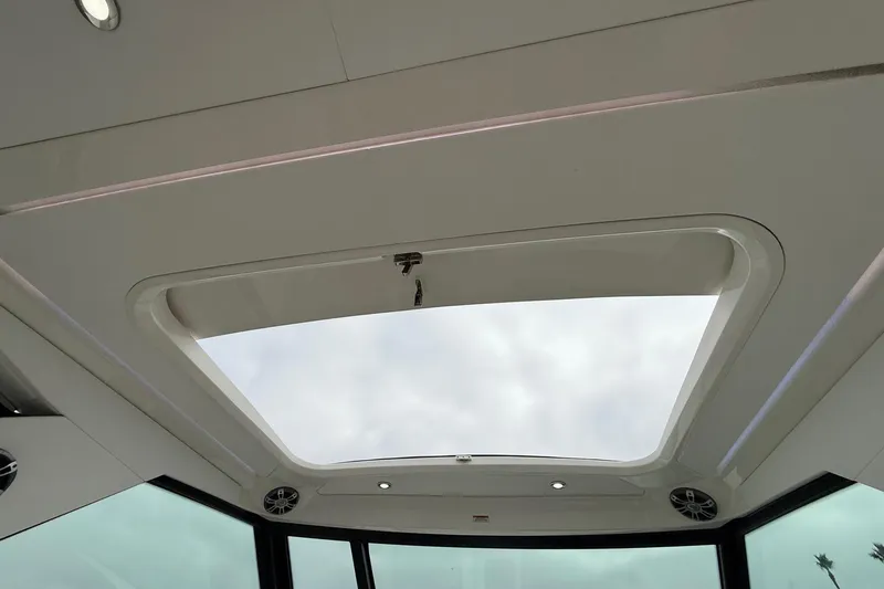 Slide: The Image of 2023 Sea Ray Sundancer 320 Coupe cockpit with modern controls and luxurious seating. - 38