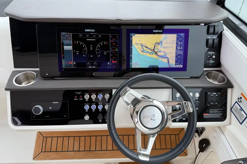 Slide: The Image of 2023 Sea Ray Sundancer 320 Coupe cockpit with modern controls and luxurious seating. - 43