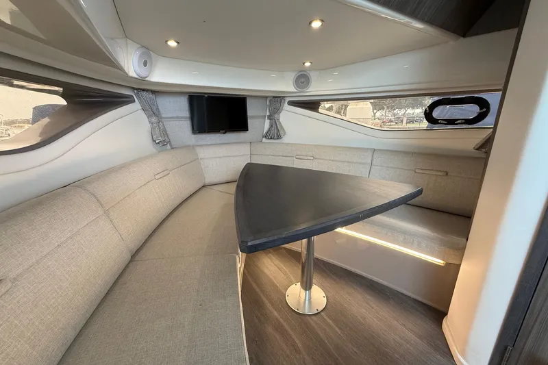 Slide: The Image of 2023 Sea Ray Sundancer 320 Coupe dashboard with navigation screens and steering wheel. - 46