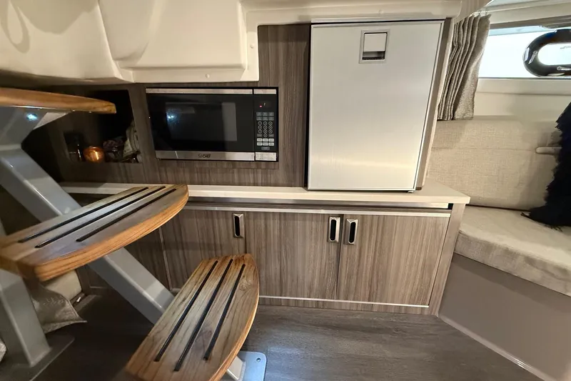 Slide: The Image of Interior of 2023 Sea Ray Sundancer 320 Coupe with elegant seating and modern table. - 54
