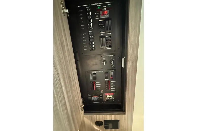 Slide: The Image of Interior cabin of 2023 Sea Ray Sundancer 320 Coupe with beige seating and decorative pillows. - 59