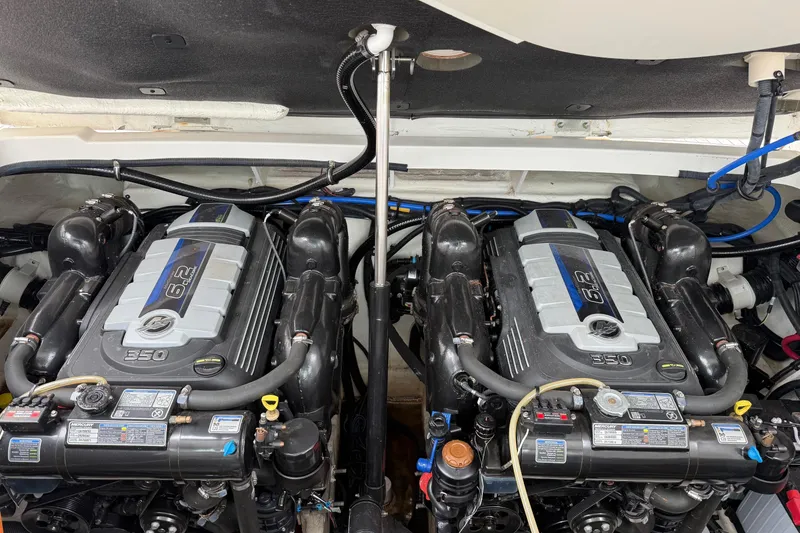 Slide: The Image of Twin engines of a 2023 Sea Ray Sundancer 320 Coupe, showcasing detailed mechanical components. - 61