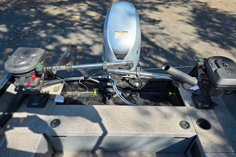 Slide: The Image of 2018 Alumacraft Escape 165 CS boat interior with motor and controls. - 11