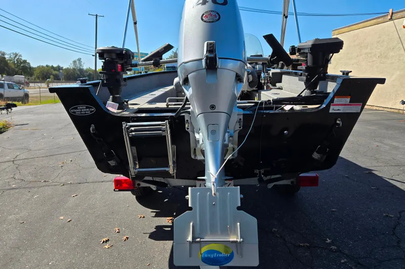 Slide: The Image of 2018 Alumacraft Escape 165 CS boat rear view with motor and trailer. - 9