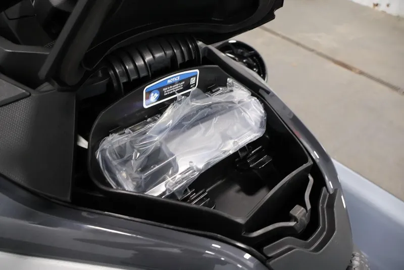 Slide: The Image of Open storage compartment of 2026 Sea-Doo RXT-X 325 watercraft, showcasing interior details. - 12