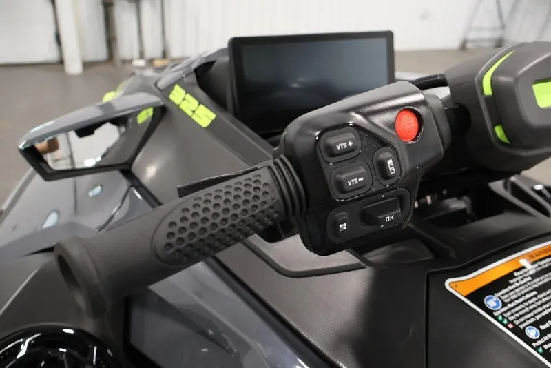 Slide: The Image of 2026 Sea-Doo RXT-X 325 handlebar controls with display screen and buttons. - 16