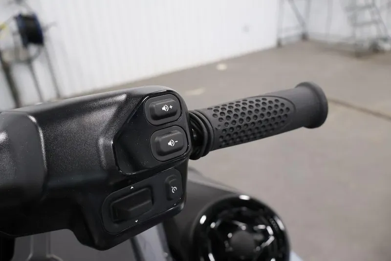 Slide: The Image of Handlebar controls of 2026 Sea-Doo RXT-X 325 with textured grip and buttons. - 19