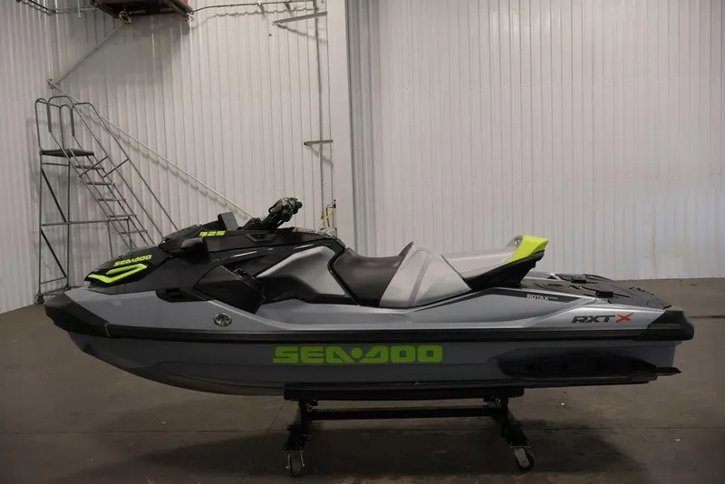 Slide: The Image of 2026 Sea-Doo RXT-X 325 jet ski in a showroom, featuring sleek design and vibrant accents. - 21