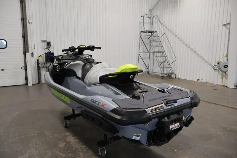 Slide: The Image of 2026 Sea-Doo RXT-X 325 jet ski in a garage, showcasing sleek design and vibrant colors. - 22