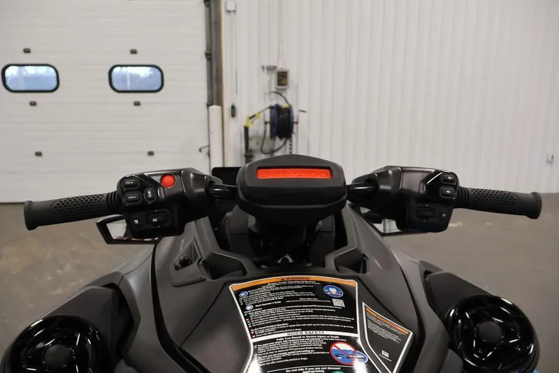 Slide: The Image of 2026 Sea-Doo RXT-X 325 handlebars and dashboard in a garage setting. - 11