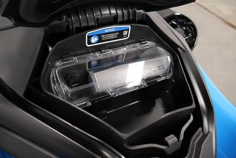 Slide: The Image of 2026 Sea-Doo RXT-X 325 storage compartment with USB port and protective cover. - 15