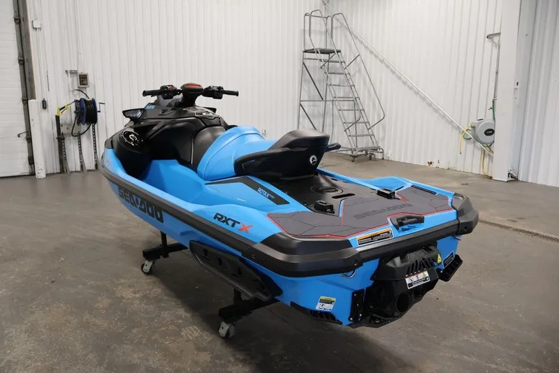 Slide: The Image of 2026 Sea-Doo RXT-X 325 jet ski in a garage, showcasing sleek blue design. - 5