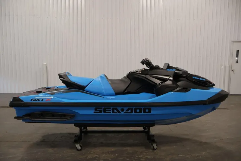 Slide: The Image of 2026 Sea-Doo RXT-X 325 jet ski in vibrant blue, displayed indoors. - 6