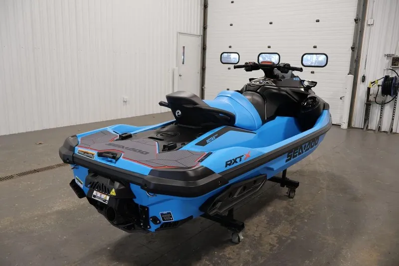 Slide: The Image of 2026 Sea-Doo RXT-X 325 jet ski in a garage, showcasing sleek blue design. - 7