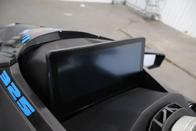 Slide: The Image of 2026 Sea-Doo RXT-X 325 dashboard with digital display in a garage setting. - 8
