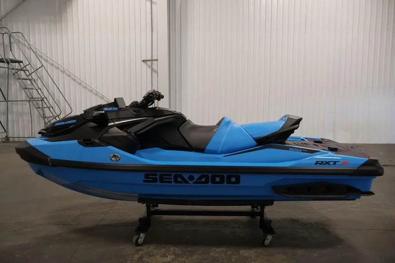 Slide: The Image of 2026 Sea-Doo RXT-X 325 jet ski in blue, displayed indoors on a stand. - 9