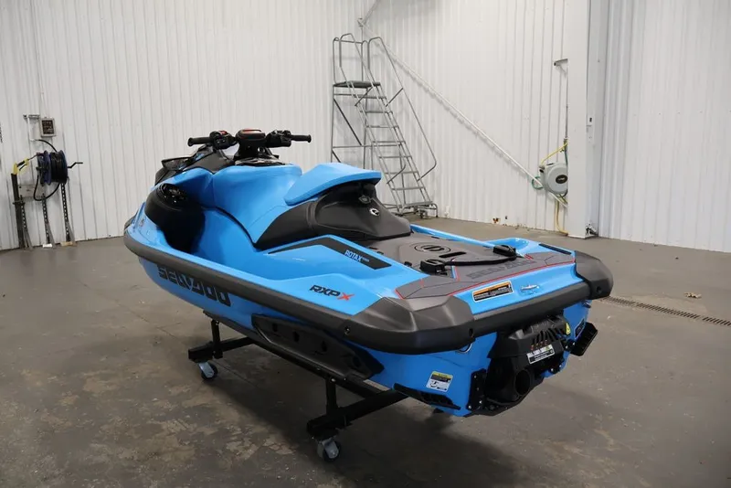 Slide: The Image of 2026 Sea-Doo RXP-X 325 jet ski in a garage, showcasing sleek blue design. - 15