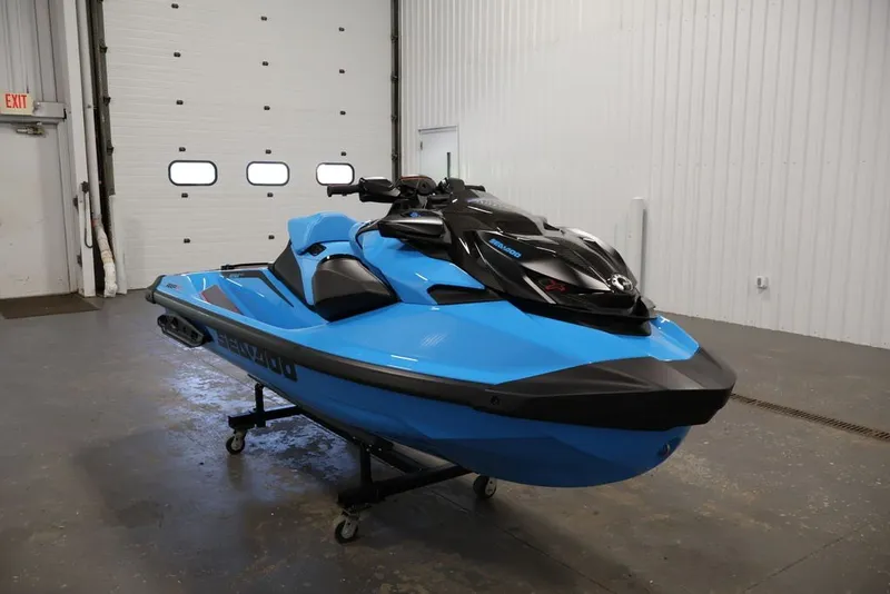 Slide: The Image of 2026 Sea-Doo RXP-X 325 jet ski in a garage, showcasing sleek blue design. - 7