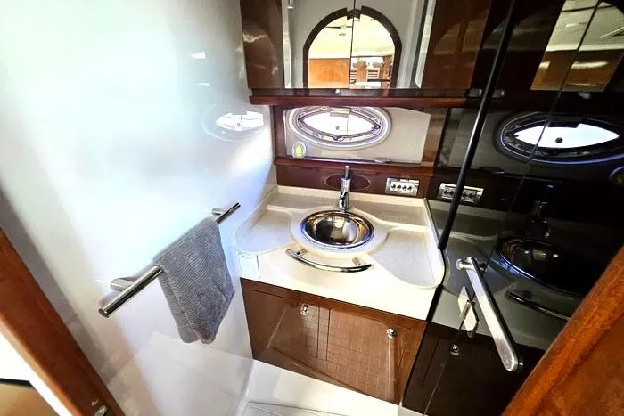 Slide: The Image of Luxurious enclosed head of 2014 Four Winns V375 yacht with modern sink and mirror. - 10