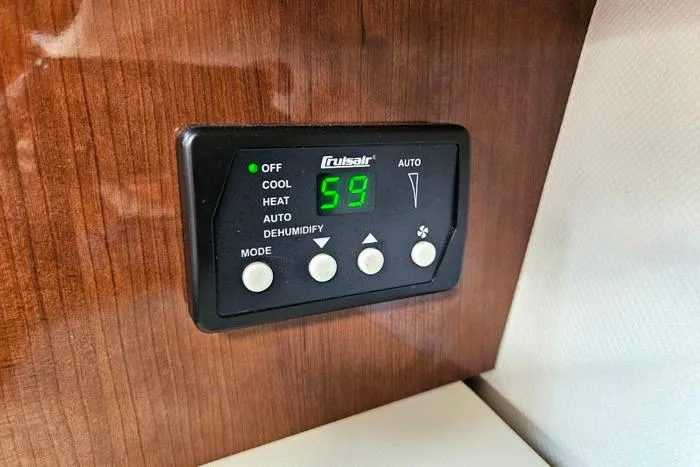 Slide: The Image of Thermostat control panel in 2014 Four Winns V375 boat interior. - 14