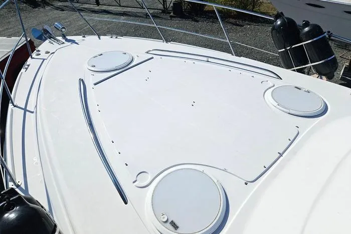 Slide: The Image of 2014 Four Winns V375 boat deck with hatches and railing, docked outdoors. - 15