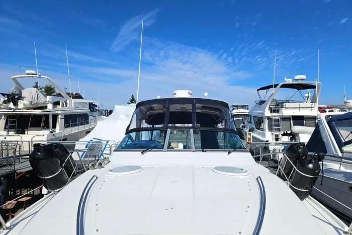 Slide: The Image of 2014 Four Winns V375 yacht docked among other boats under a clear blue sky. - 16