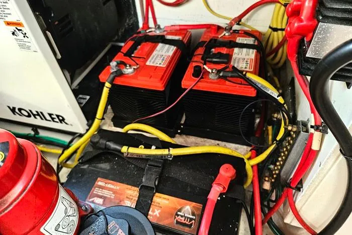 Slide: The Image of Engine compartment of 2014 Four Winns V375 with batteries and wiring. - 25